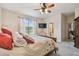 Comfortable bedroom featuring a ceiling fan, TV, and large windows for ample natural light at 20244 Merry Oak Ave, Tampa, FL 33647