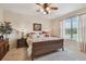 Comfortable bedroom with a large window, neutral walls, and coordinated furniture at 20244 Merry Oak Ave, Tampa, FL 33647