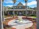 Clubhouse exterior featuring a fountain, palm trees and lush landscaping on a bright sunny day at 20244 Merry Oak Ave, Tampa, FL 33647