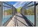 Pedestrian bridge crossing over community pool with a black fence at 20244 Merry Oak Ave, Tampa, FL 33647