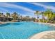 Community pool featuring lush landscaping, a pedestrian bridge and resort-style lounge seating at 20244 Merry Oak Ave, Tampa, FL 33647
