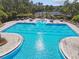 Community pool and tennis courts with tables and lounge seating available at 20244 Merry Oak Ave, Tampa, FL 33647