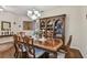 Formal dining area showcasing a large wooden table, hardwood floors and a hutch filled with decor at 20244 Merry Oak Ave, Tampa, FL 33647