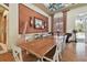 Spacious dining room with a long wooden table, white chairs, bamboo wall decor, and hardwood floors at 20244 Merry Oak Ave, Tampa, FL 33647