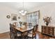 Elegant dining room featuring a chandelier, hardwood floors, and a large wooden table set for eight at 20244 Merry Oak Ave, Tampa, FL 33647