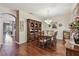 Formal dining room with a hardwood floor and large hutch and decorative light fixture at 20244 Merry Oak Ave, Tampa, FL 33647