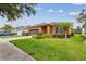Well-maintained home featuring lush landscaping, beautiful green lawn, and a large two-car garage at 20244 Merry Oak Ave, Tampa, FL 33647