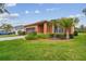 Well-maintained home featuring lush landscaping, beautiful green lawn, and a large two-car garage at 20244 Merry Oak Ave, Tampa, FL 33647
