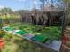 Golf cage with artificial putting surfaces, perfect for training on your short game and protected from the elements at 20244 Merry Oak Ave, Tampa, FL 33647