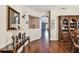 Inviting hallway features hardwood floors, decorative console table with decor and views into other living spaces at 20244 Merry Oak Ave, Tampa, FL 33647