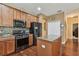 Kitchen featuring wooden cabinetry, granite countertops, stainless appliances, and an island at 20244 Merry Oak Ave, Tampa, FL 33647