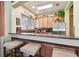 Kitchen with granite countertop, wooden cabinets, and stainless steel appliances with breakfast bar at 20244 Merry Oak Ave, Tampa, FL 33647