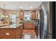 Kitchen showcasing stainless steel appliances, granite countertops, mosaic backsplash, and an island at 20244 Merry Oak Ave, Tampa, FL 33647