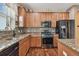 Spacious kitchen with stainless steel appliances, granite countertops, mosaic backsplash and hardwood floors at 20244 Merry Oak Ave, Tampa, FL 33647