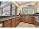 Kitchen with granite countertop, wooden cabinets, stainless steel appliances and lots of sunlight at 20244 Merry Oak Ave, Tampa, FL 33647