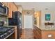 Kitchen featuring hardwood floors, stainless steel appliances, granite countertops and access to other living spaces at 20244 Merry Oak Ave, Tampa, FL 33647