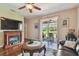 Cozy living room with a fireplace and sliding glass doors leading to a patio with outdoor seating at 20244 Merry Oak Ave, Tampa, FL 33647