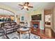 Inviting living area featuring a fireplace, mounted TV, and an open layout connecting to the kitchen at 20244 Merry Oak Ave, Tampa, FL 33647
