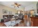 Spacious living room with hardwood floors, leather sofas, and an open view to the kitchen at 20244 Merry Oak Ave, Tampa, FL 33647