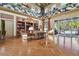 Lounge area featuring hardwood floors, comfortable seating, and access to a patio area with pool views at 20244 Merry Oak Ave, Tampa, FL 33647