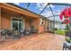 Relaxing screened patio with seating area and view of the landscaped backyard at 20244 Merry Oak Ave, Tampa, FL 33647