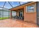 Covered lanai with a textured concrete floor, ceiling fan and outdoor furniture at 20244 Merry Oak Ave, Tampa, FL 33647