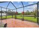 Spacious screened-in patio with view of the pond and landscaped backyard at 20244 Merry Oak Ave, Tampa, FL 33647