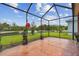 Open screened-in patio with a beautiful view of the lake and landscaping at 20244 Merry Oak Ave, Tampa, FL 33647