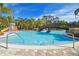 An inviting swimming pool with a area and a bridge, surrounded by palm trees, offers relaxation and fun for all at 20244 Merry Oak Ave, Tampa, FL 33647