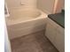 A clean bathroom shows a cream soaking tub adjacent to a vanity with a green countertop at 205 Summer Sails Dr, Valrico, FL 33594