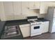 Functional kitchen featuring white cabinets, laminate counters, and modern appliances at 205 Summer Sails Dr, Valrico, FL 33594