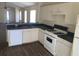 Bright eat-in kitchen with white cabinets, modern appliances, and seamless connection to the living area at 205 Summer Sails Dr, Valrico, FL 33594