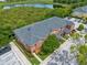 Aerial view of townhomes with a pond, mature trees, and lots of parking at 2066 Sun Down Dr, Clearwater, FL 33763