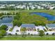 Aerial view of townhomes near a peaceful pond, set amongst lush greenery and neighborhood streets at 2066 Sun Down Dr, Clearwater, FL 33763