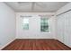 Bedroom with hardwood floors, ceiling fan, and dual windows at 2066 Sun Down Dr, Clearwater, FL 33763