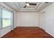 Large bedroom features hardwood floors, ceiling fan, and ample closet space at 2066 Sun Down Dr, Clearwater, FL 33763