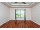 Spacious bedroom with tray ceilings, ceiling fan, and hardwood floors at 2066 Sun Down Dr, Clearwater, FL 33763