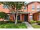 Charming two-story townhome with a well-maintained lawn, shrubs, and shade tree framing the front entrance at 2066 Sun Down Dr, Clearwater, FL 33763