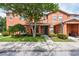 Inviting two-story townhome with lush landscaping and a well-manicured lawn at 2066 Sun Down Dr, Clearwater, FL 33763