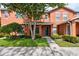 Inviting two-story townhome with lush landscaping and a well-manicured lawn at 2066 Sun Down Dr, Clearwater, FL 33763
