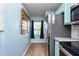 Kitchen with blue cabinetry, stainless steel appliances, and a window for natural light at 2066 Sun Down Dr, Clearwater, FL 33763