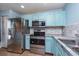 Well-equipped kitchen with stainless steel appliances, light blue cabinets, and a convenient layout at 2066 Sun Down Dr, Clearwater, FL 33763