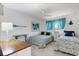 Bright bedroom with twin beds, white walls, and coastal-themed decor for a serene atmosphere at 221 Fernwood Cir # 221, Seminole, FL 33777