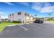 Exterior of condo building with dedicated parking spaces for residents, landscaped lawns, and parking at 221 Fernwood Cir # 221, Seminole, FL 33777