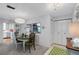 Bright dining area with a stylish chandelier and easy access to the kitchen, perfect for entertaining at 221 Fernwood Cir # 221, Seminole, FL 33777