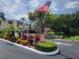 Welcoming entrance to Fernwood Circle, a 55+ community with well-maintained landscaping and palm trees at 221 Fernwood Cir # 221, Seminole, FL 33777