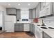 Well-lit kitchen featuring grey cabinets, white appliances, and wood-look flooring for a cozy feel at 221 Fernwood Cir # 221, Seminole, FL 33777