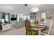 Open-concept living and dining area with stylish furnishings, creates a bright and inviting space at 221 Fernwood Cir # 221, Seminole, FL 33777