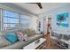 Bright living room featuring a comfortable sofa, views of the outside, and an adjacent dining area at 221 Fernwood Cir # 221, Seminole, FL 33777