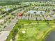 Scenic aerial view of a residential neighborhood featuring a golf course, multiple lakes, and lush green spaces at 2292 Sifield Greens Way # 59, Sun City Center, FL 33573